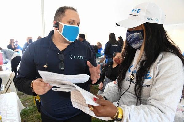 George Fernandez and woman volunteer