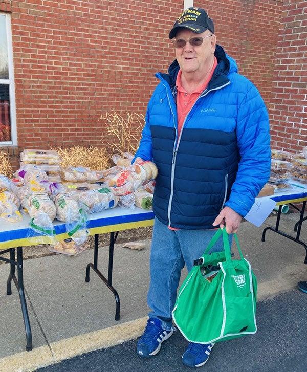 Smiling man with loaf of bread