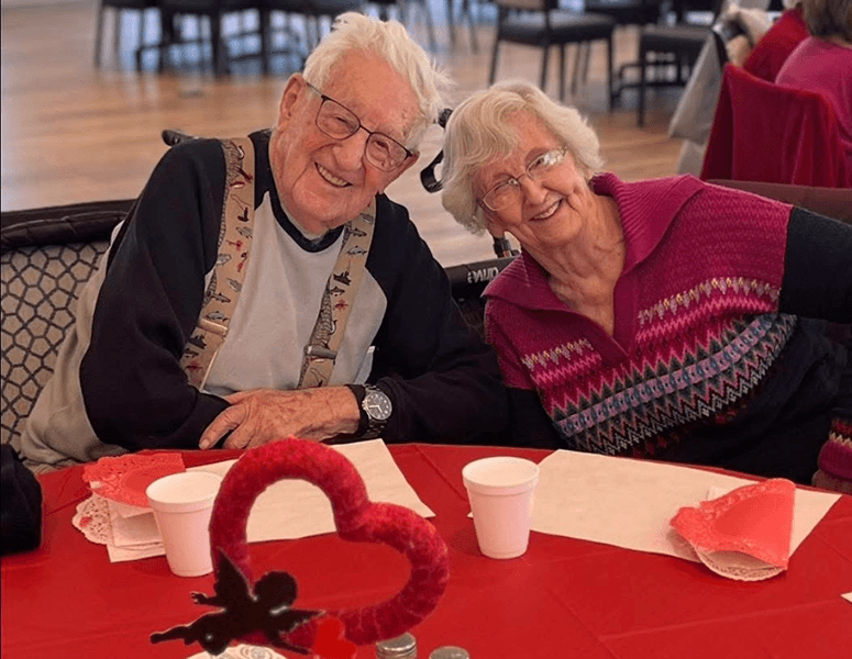 Smiling older man and woman at Valentine's Day themed meal