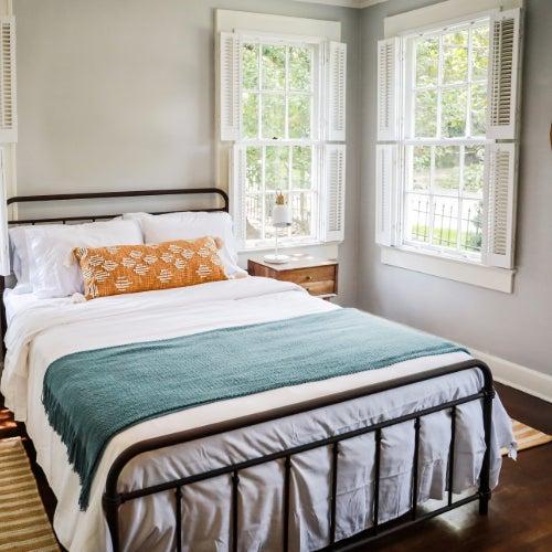 A bedroom with a queen sized DreamCloud bed and nightstand