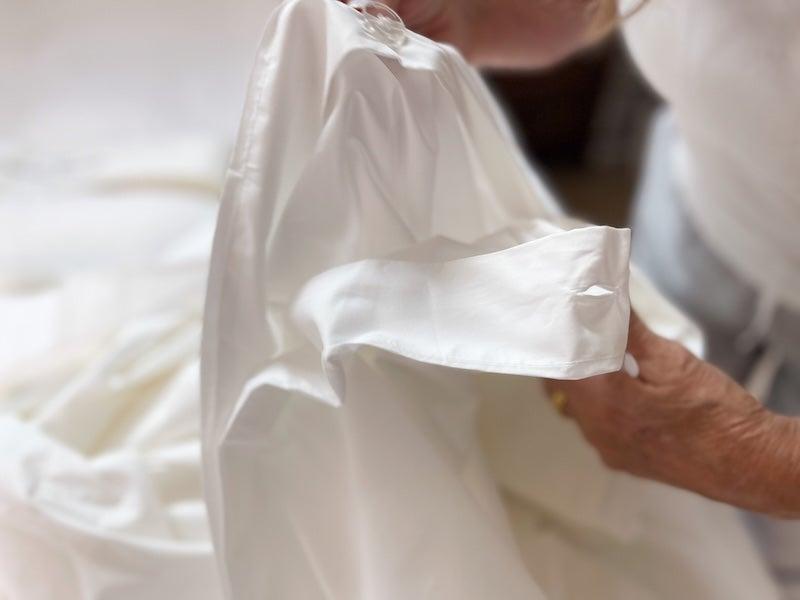 A close up of the Brooklinen Classic Duvet Cover’s button closure