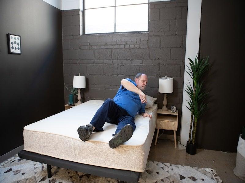 A man in the process of rolling over on the Birch Natural latex hybrid mattress