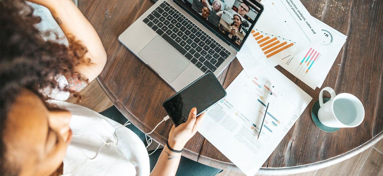 A healthcare professional is in an online meeting while working from home during the pandemic.