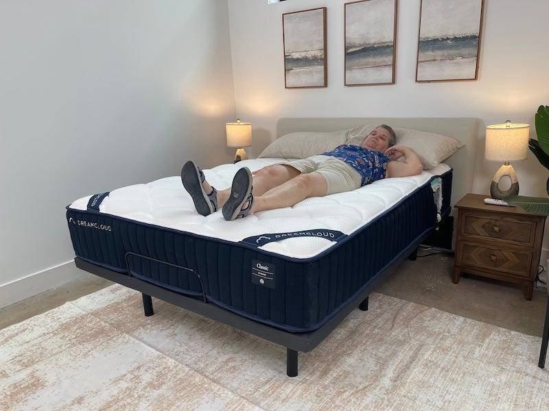A woman lying on her back on the DreamCloud Classic Hybrid mattress
