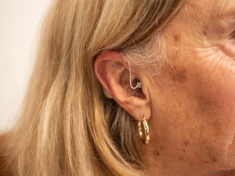 The Zepp Clarity Omni hearing aid inside a woman's ear