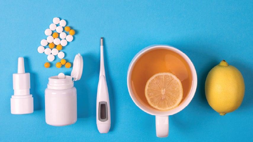 Close up of items that might help someone get better after getting RSV, including medication, hot tea, vitamin C, among others.