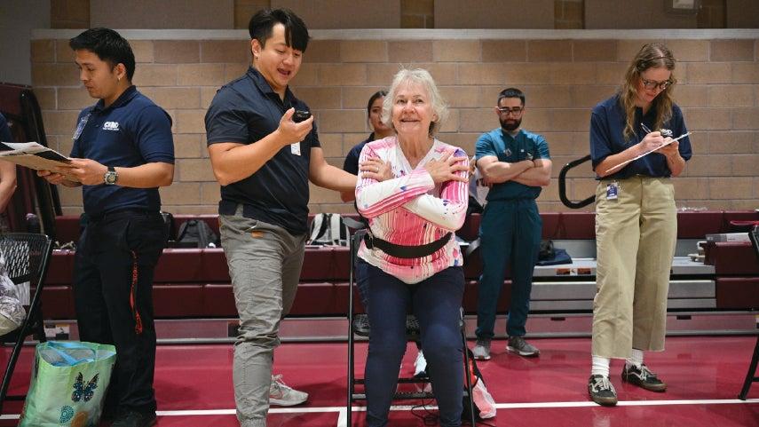 An older caucasian woman is attendance a falls prevention program in her community.