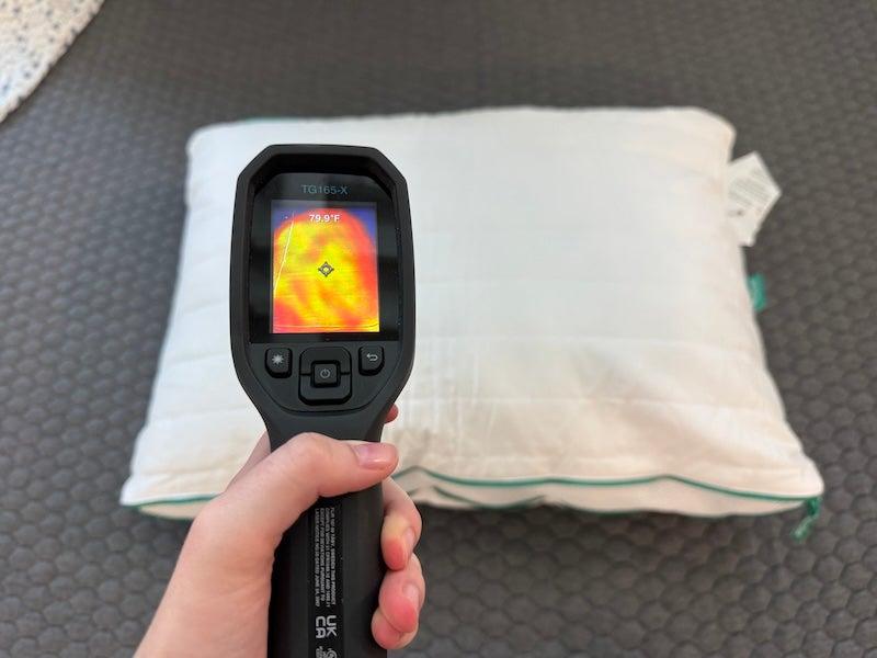 A heat gun is held above the Brooklinen Marlow memory foam pillow.