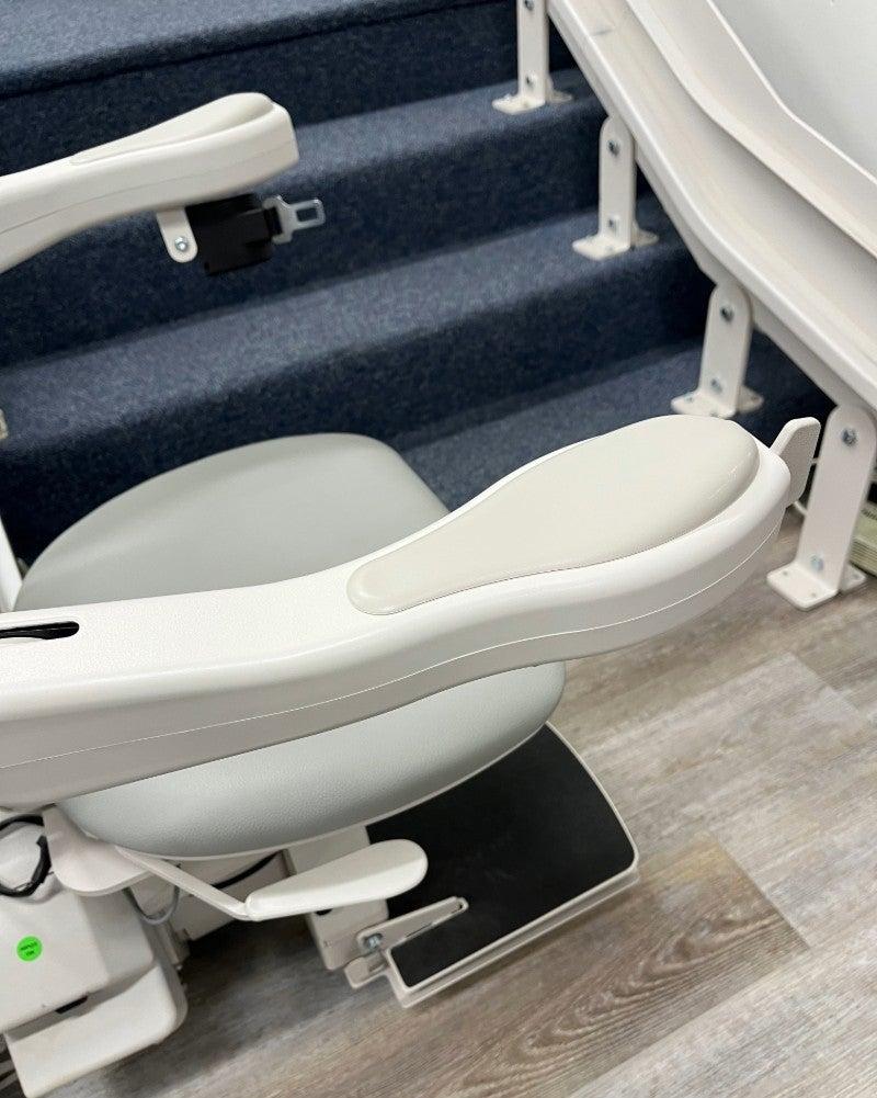 The Bruno Elite stairlift at the base of a short set of stairs