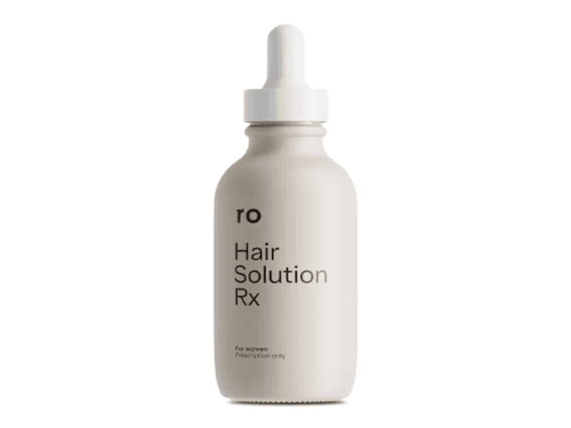 Off-white dropper bottle of Ro Hair Solution Rx against a white background.