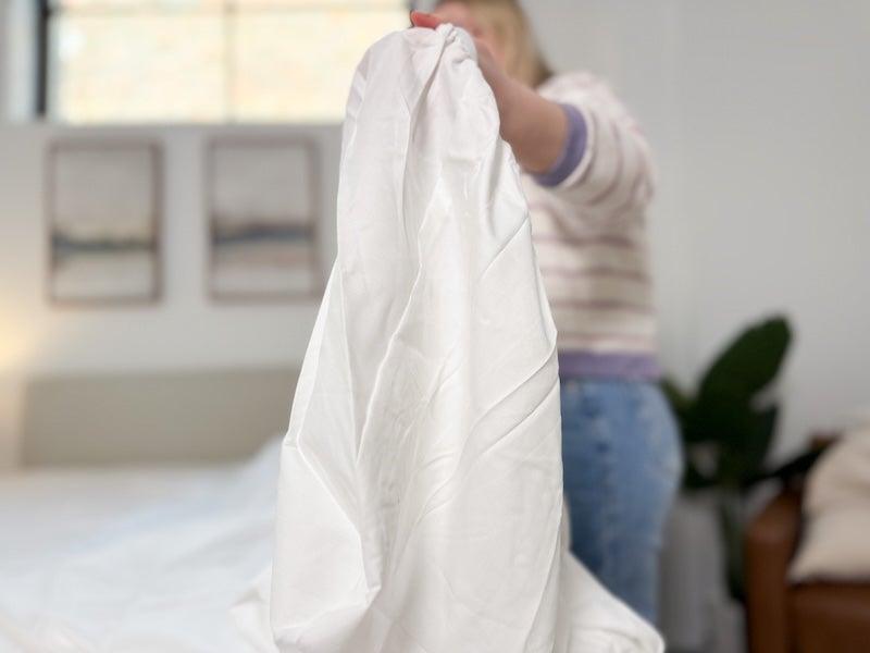 A tester holds up the Nectar Serenity Bamboo sheet