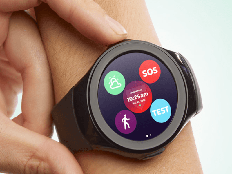 Black smartwatch with SOS button and other features shown on someone’s wrist