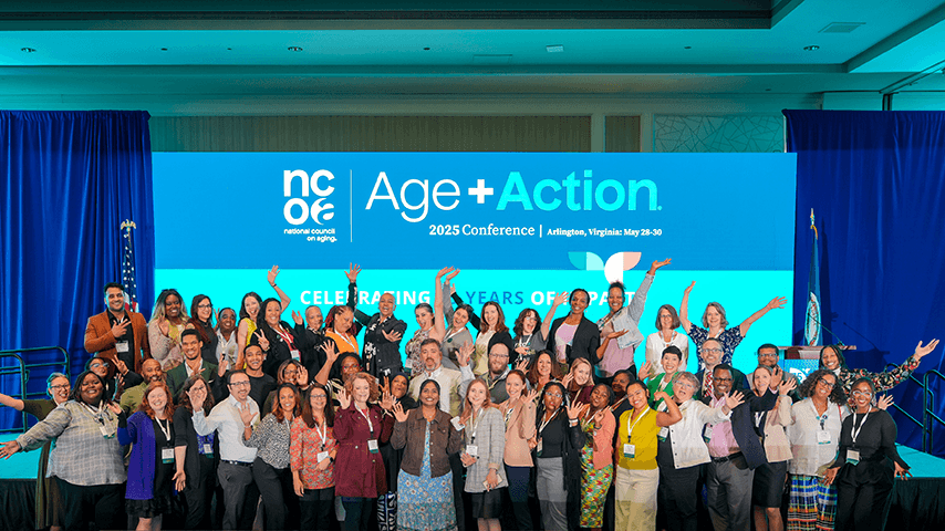 NCOA staff in front of Age+Action 2025 banner