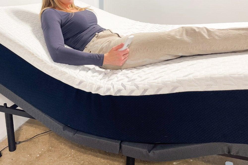woman lying on top of the Nectar Memory Foam on an adjustable base