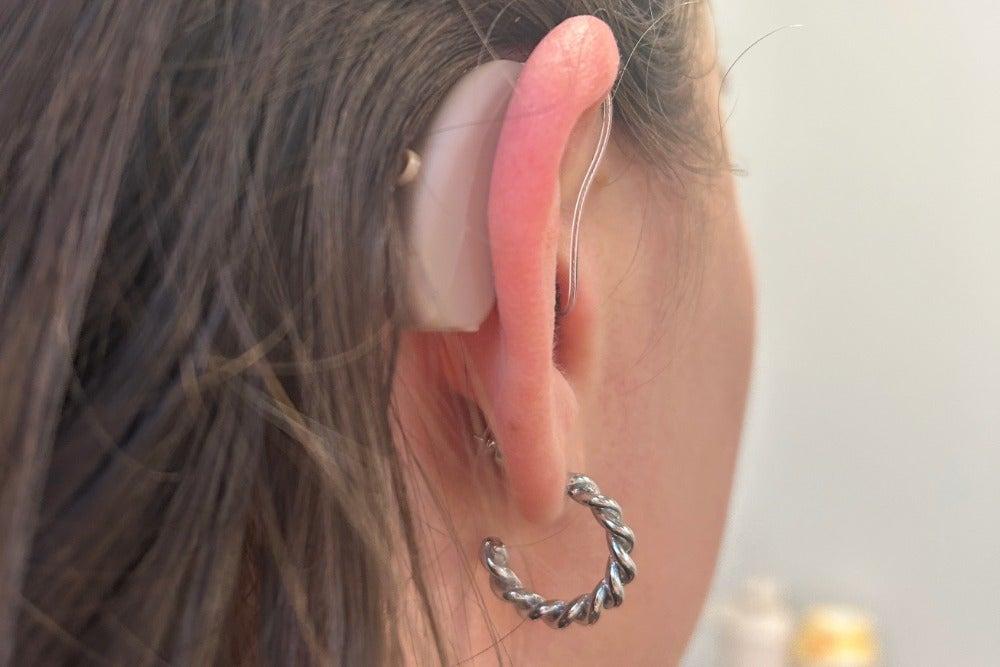 Audien hearing aid in woman's right ear