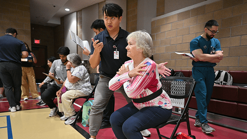 physical therapy student checking older woman's fall risk at community event