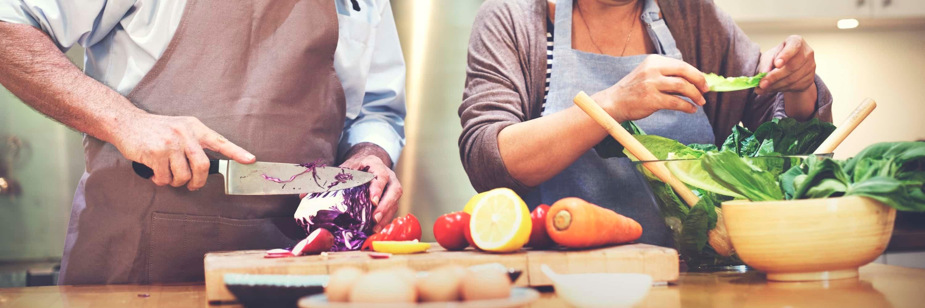 Shot of a family cutting produce and preparing for a nutritious meal.