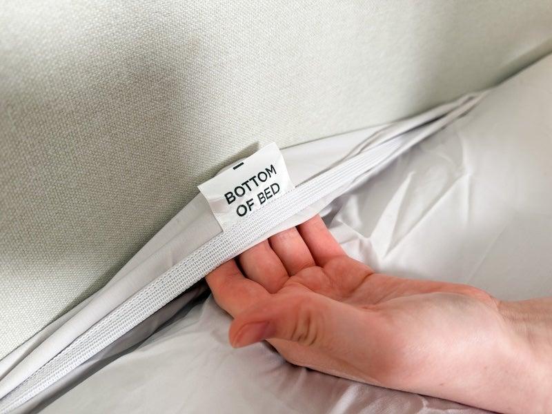 A tag inside the Tempur-Pedic fitted sheet reads “bottom of the bed”