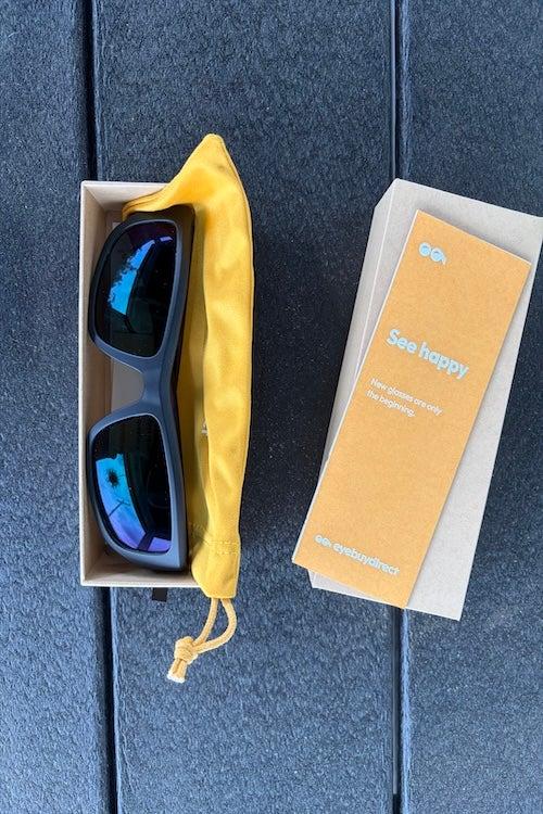 Sunglasses and a dandelion-yellow glasses case