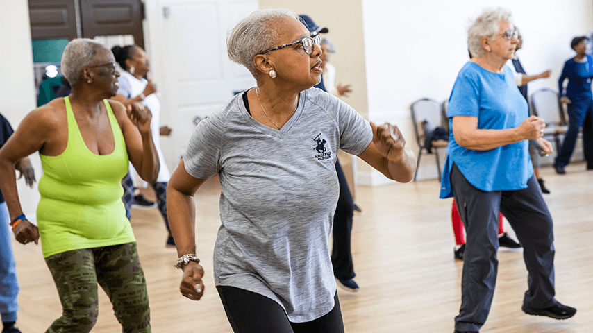 three older women dancing in exercise class