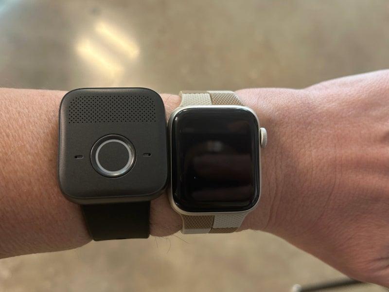 The Bay Alarm Medical SOS Micro next to an Apple Watch on a person's wrist