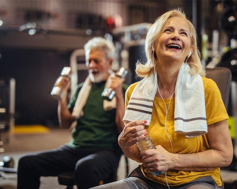 how to minimize presentation in google meet A senior woman in her gym clothes takes a break from exercising while smiling and holding a bottle of water. Her husband is in the foreground seen lifting dumbbells.