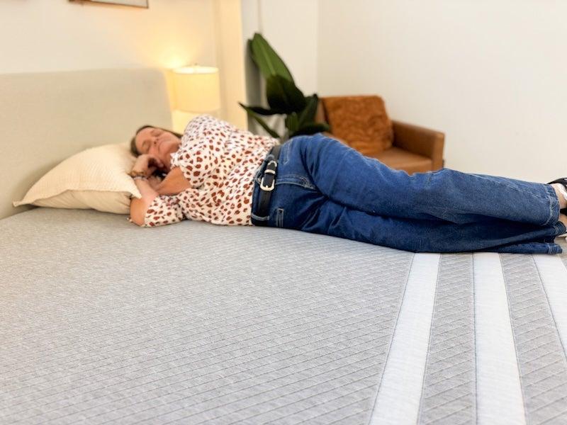 A woman lies on her side on the Leesa Original Memory Foam mattress