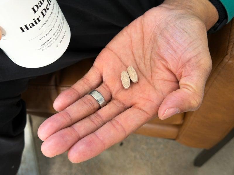 A daily dose of Keeps Daily Hair Defense Supplement in our tester’s hand
