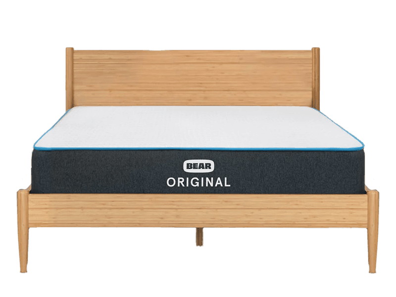 The Bear Original mattress without sheets, displayed with a wooden headboard and footboard