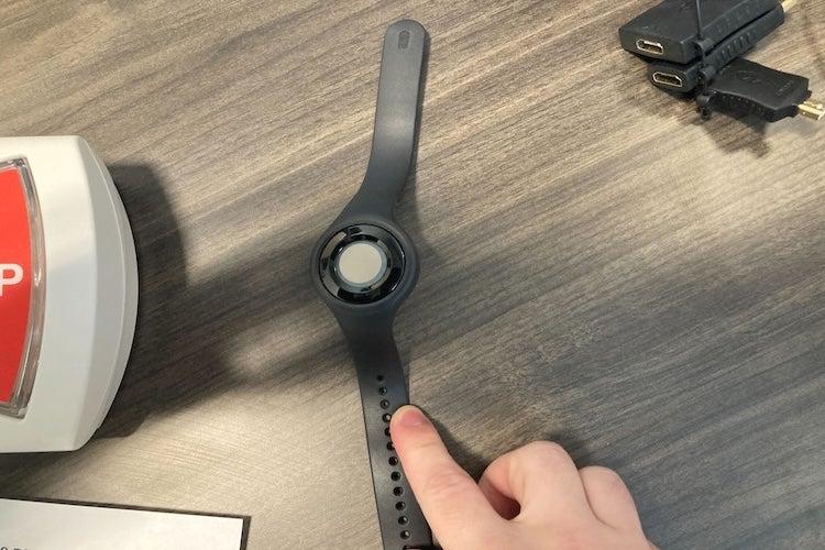 Hand touching Bay Alarm AtHome wristband