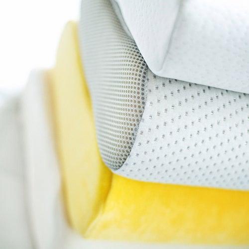 A stack of memory foam pillows against a white background.