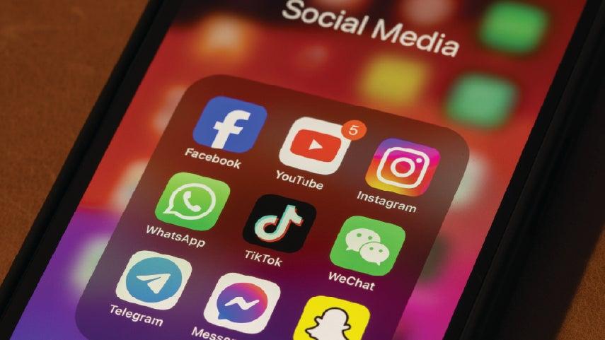 Close up shot of a mobile phone with the social media apps front and center.