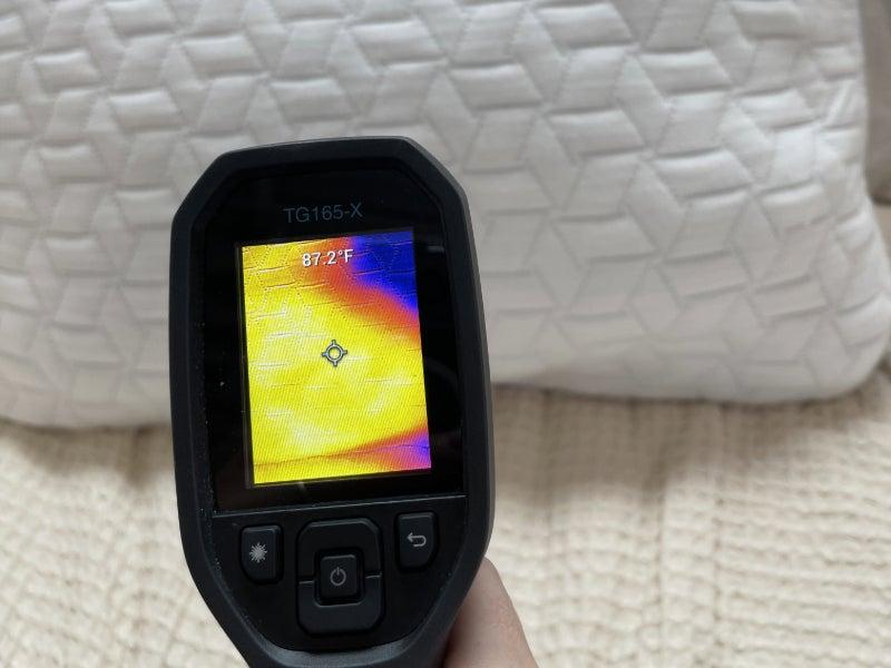 A thermal gun reads the heat signature of the Luxome LAYR pillow