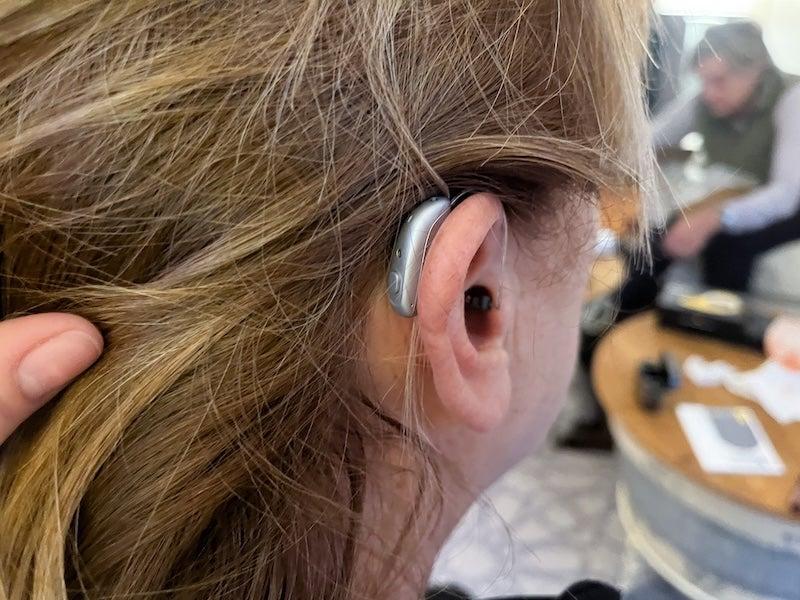 A woman wearing the Jabra Enhance Select 700 hearing aids