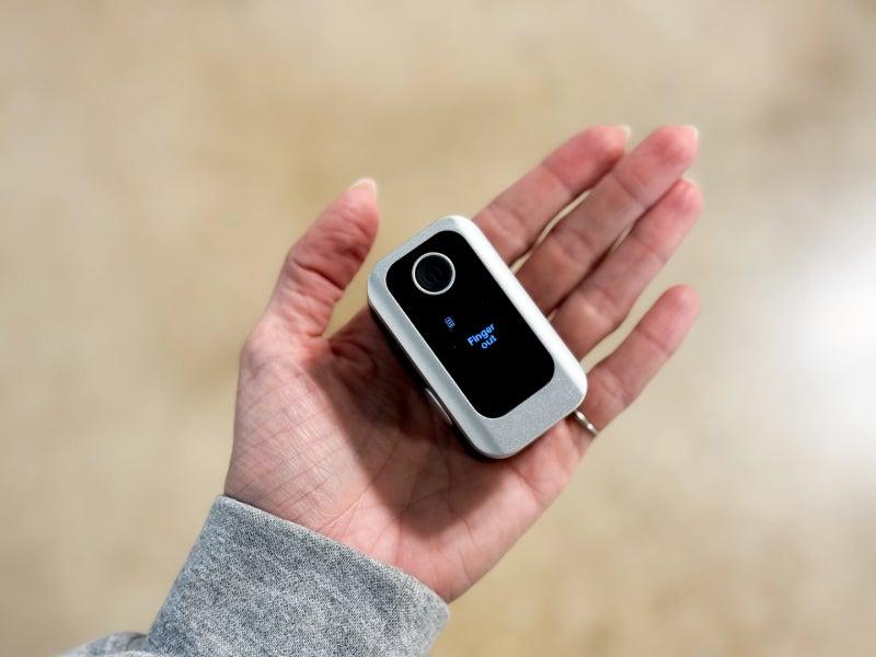 The Oxiline XS Pro in the palm of a person's hand