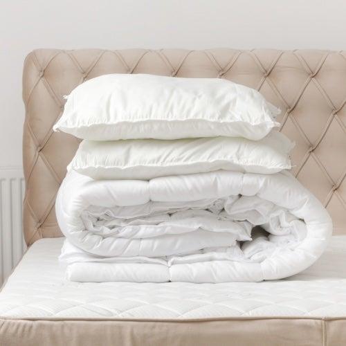 A soft-looking comforter folded on a bed