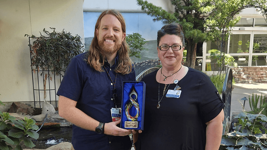 Shasta Community Health Center HOPE program Medical Director Dr. Kyle Patton and Senior Director Amber Middleton with the Lloyd H. Dean Institute for Humankindness & Health Justice Award from Common Spirit Health