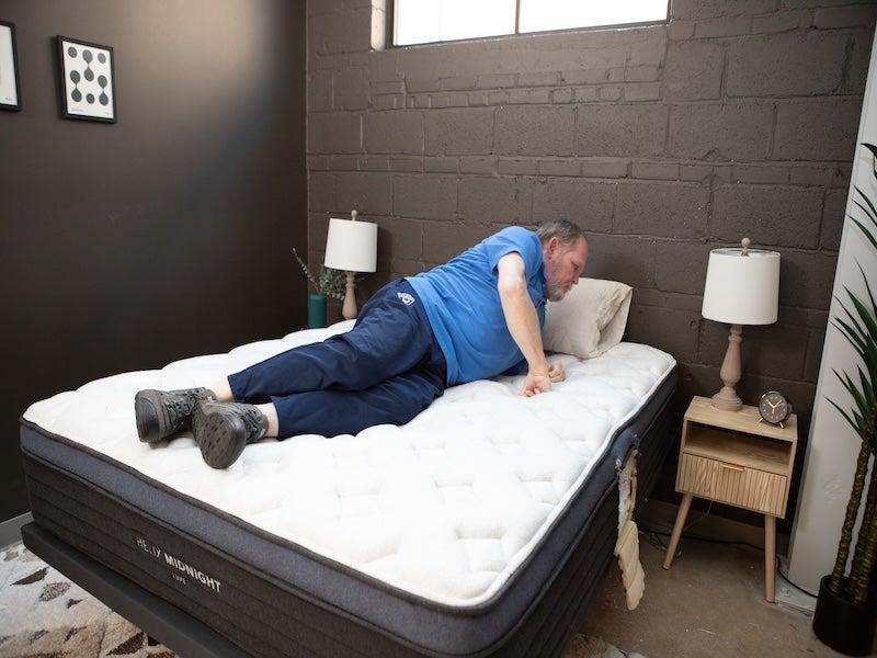 A man turning over on the Helix Midnight Luxe mattress