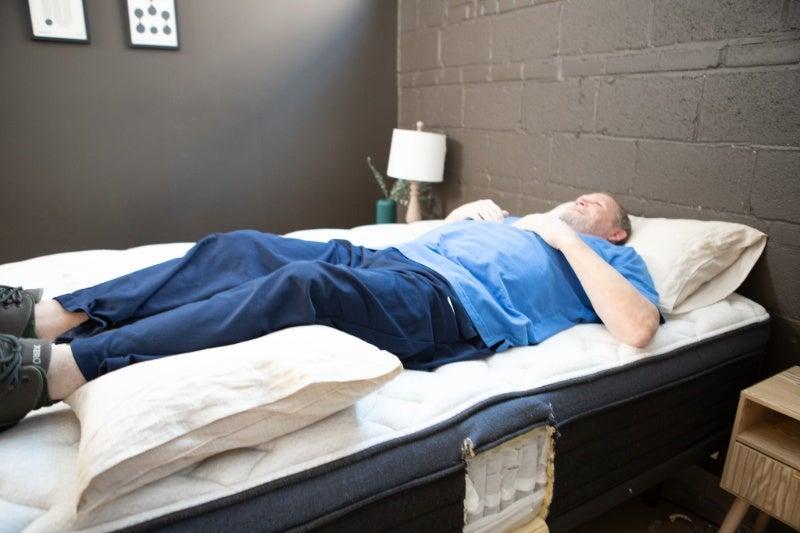 A many lying on his back near the edge of the Helix Midnight Luxe