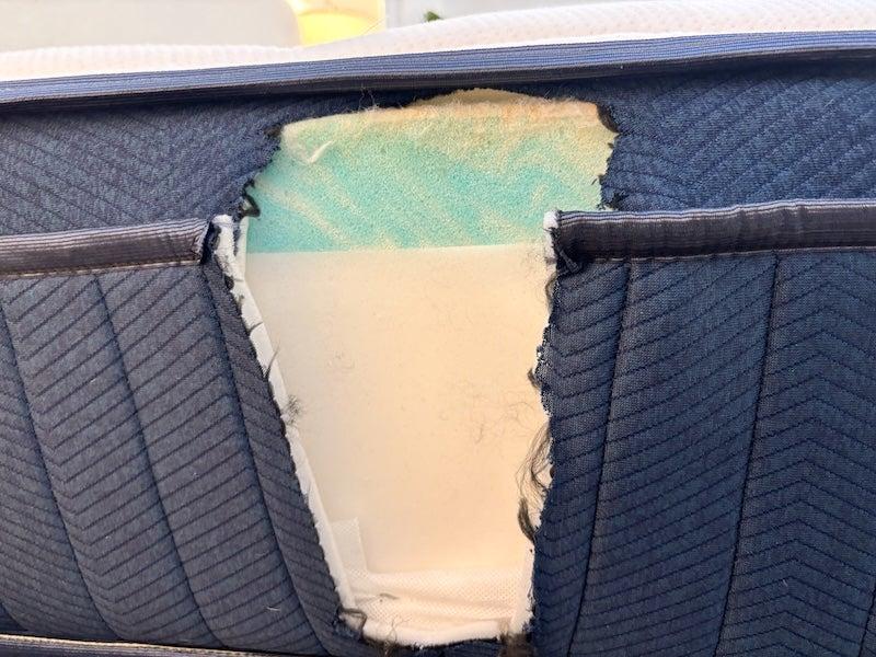 A Silk & Snow Hybrid mattress is cut open to show its inside constructuion.