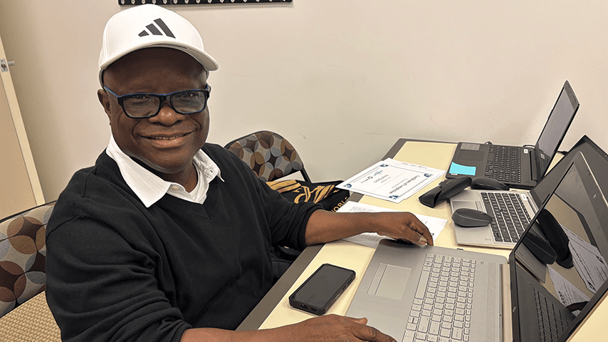 smiling older black man at laptop