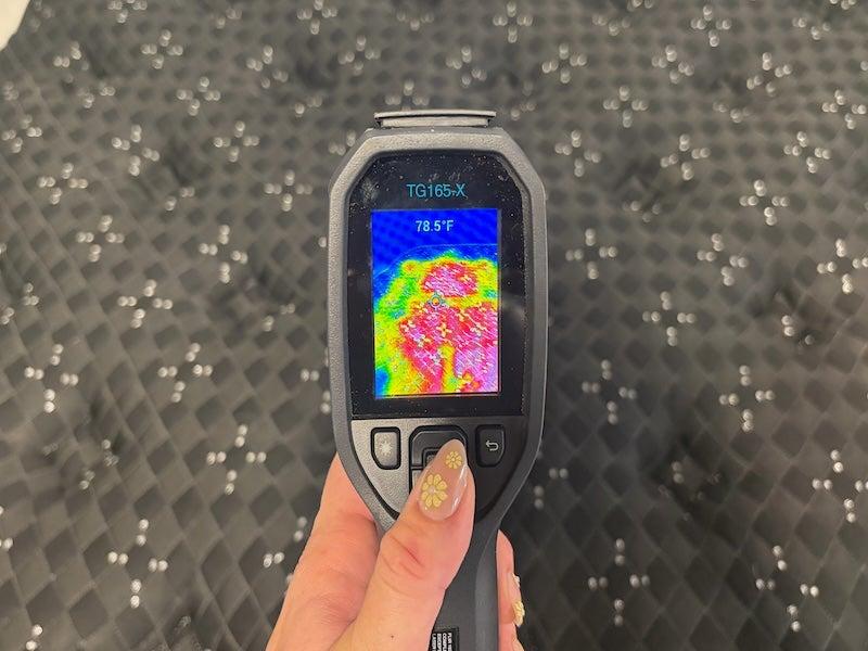 A thermal gun reads the heat signature coming off the Beautyrest Black mattress