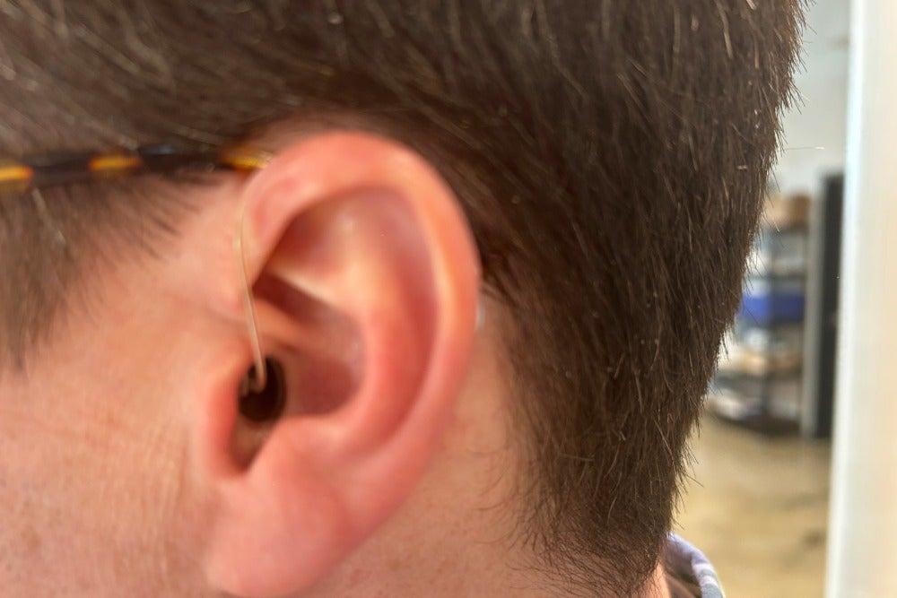 Signia hearing aid with sports lock in man's left ear