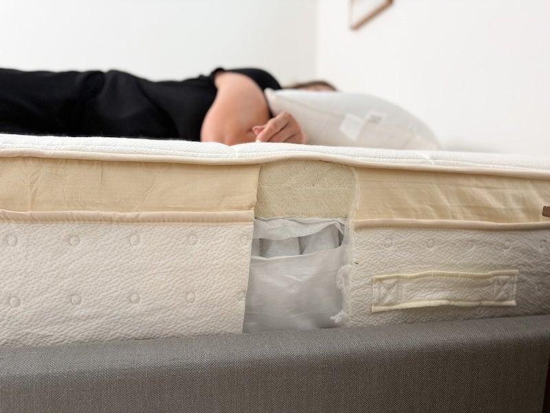 A woman lies on her stomach on the Awara Premier Hybrid mattress
