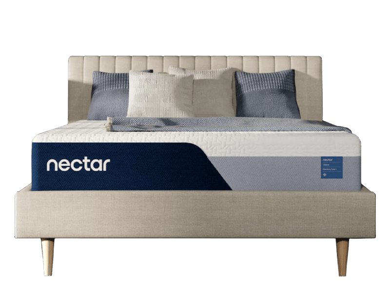 A Nectar Classic Memory Foam mattress with no sheets, a padded headboard, and four square pillows