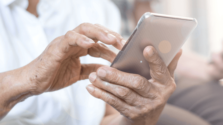 An older adult uses a phone