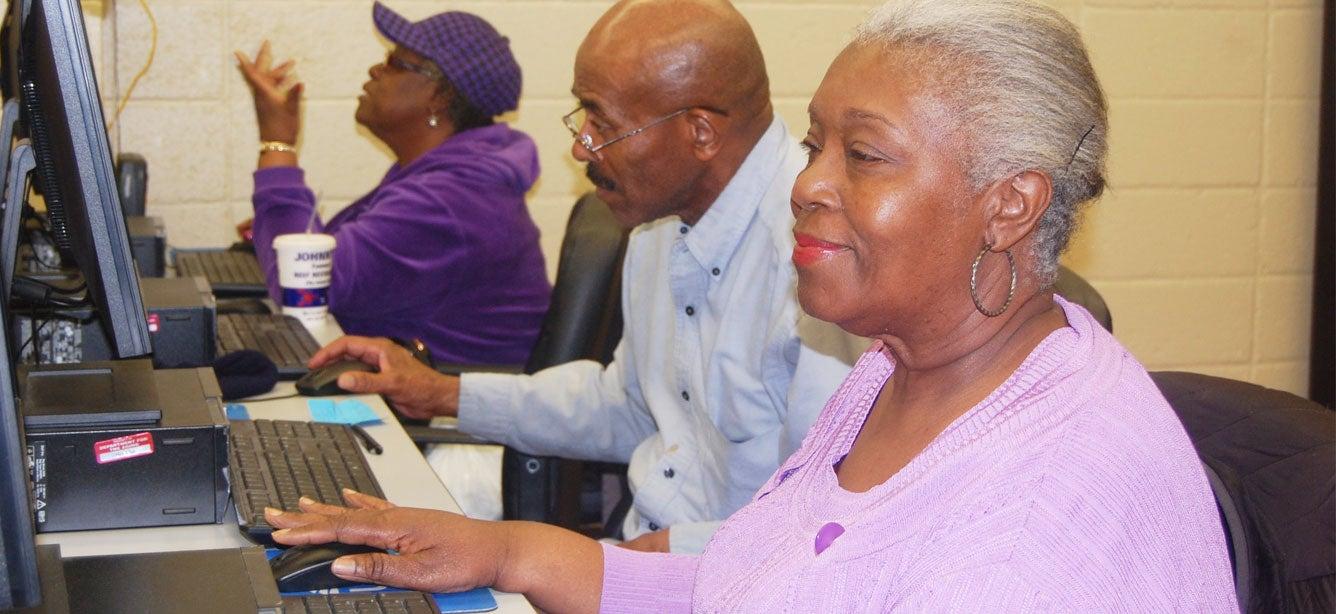 Older adults are sitting in a computer training session at the William Hodson Senior Center in the Bronx, NY. The William Hodson Senior Center, widely recognized as the first senior center in the U.S, was created to address social isolation, poor nutrition, and lack of support for older adults.