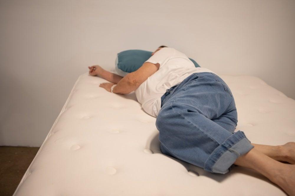 A woman lying on her side on the WinkBed Plus mattress