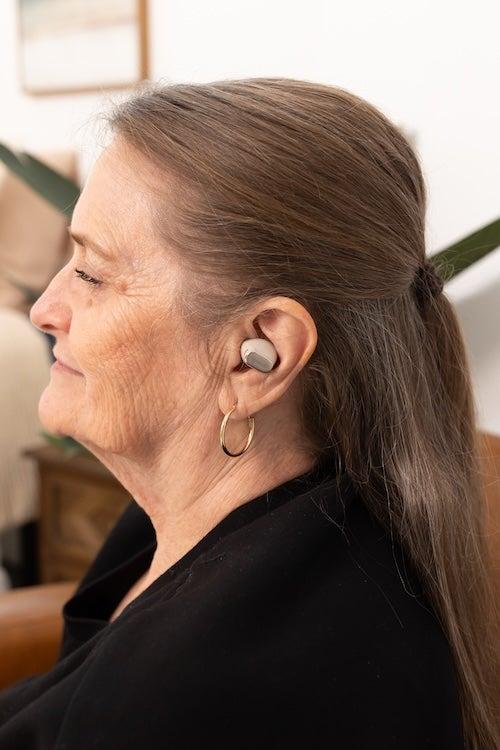 A woman wearing the Cearvol Wave hearing aids