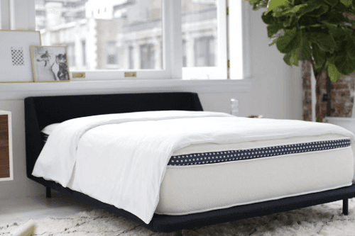 WinkBed Luxury Firm mattress on fame in bedroom in front of window